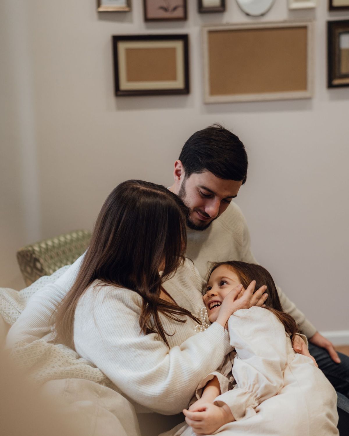 Young parents relaxing at home with their daughter