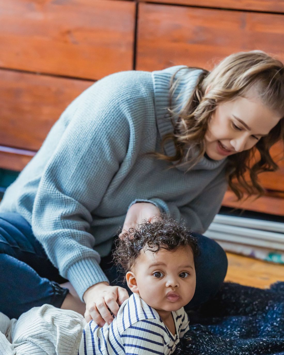 A mother playing with her baby at home